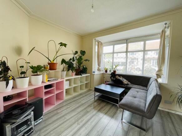 Bright and modern living room featuring a large...