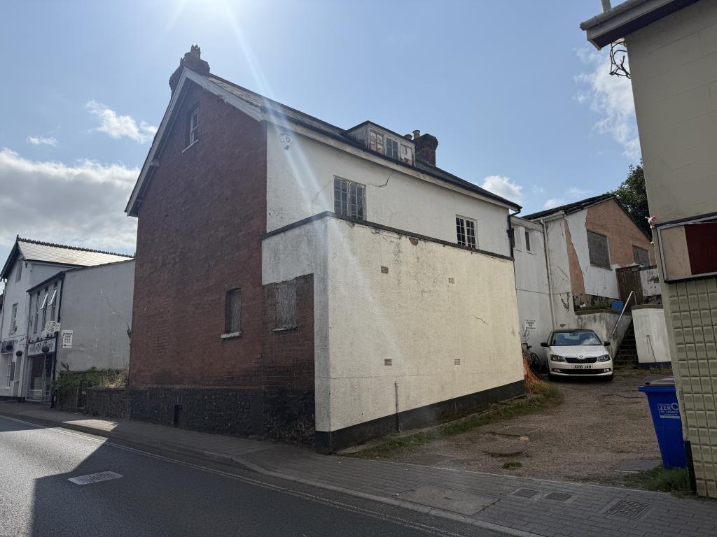 Main photo of the side and rear of the property