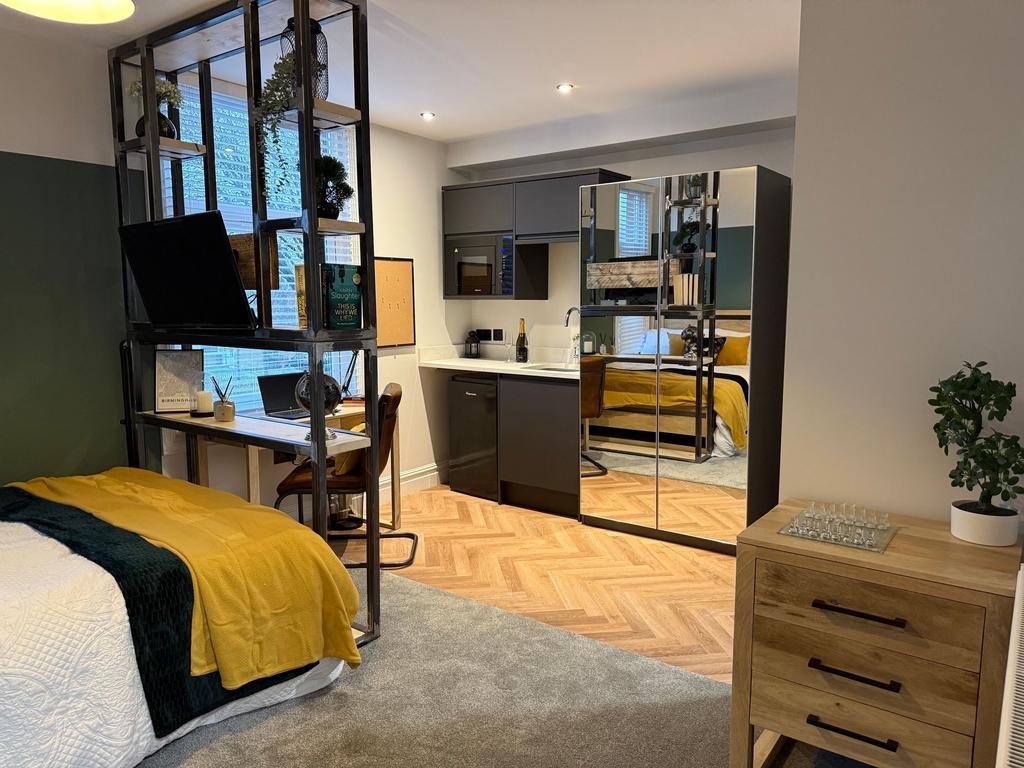 A modern and stylish single bedroom featuring a...