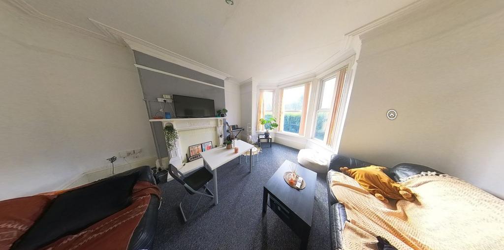 A cozy living room with a bay window providing ...