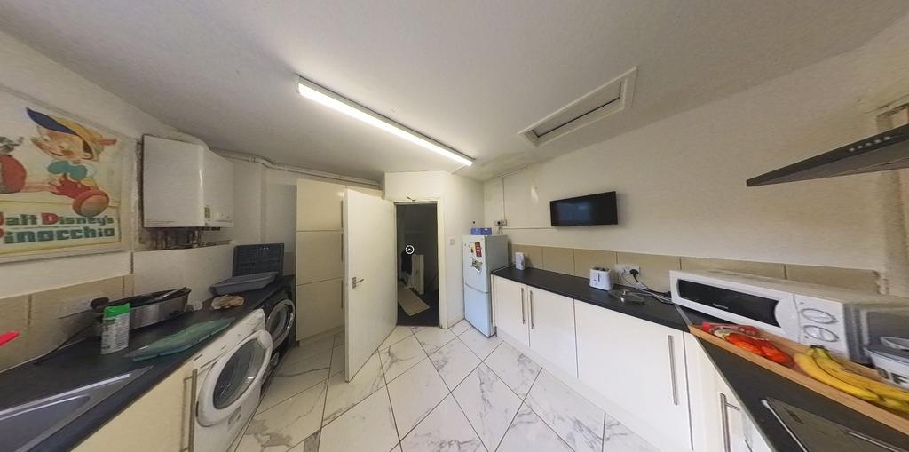 Bright and modern kitchen featuring sleek white...