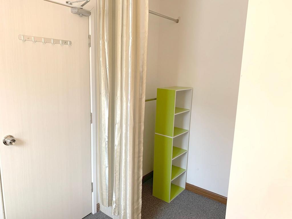 A neat and tidy small storage area featuring a ...
