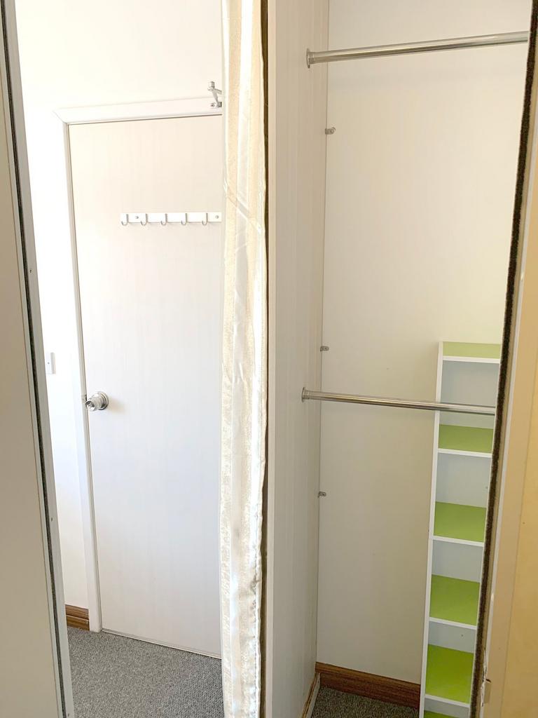 A clean and bright storage area with a white do...