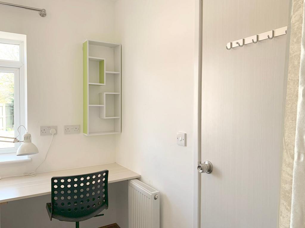 Bright and tidy study corner with a large windo...