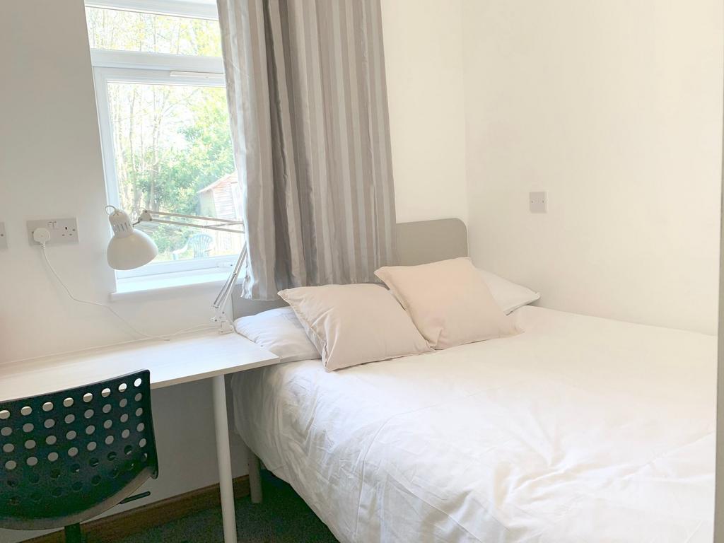 A bright and cozy double bedroom featuring a co...
