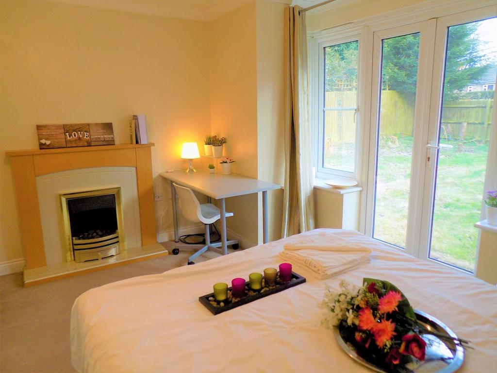 A cozy and bright master bedroom featuring a co...