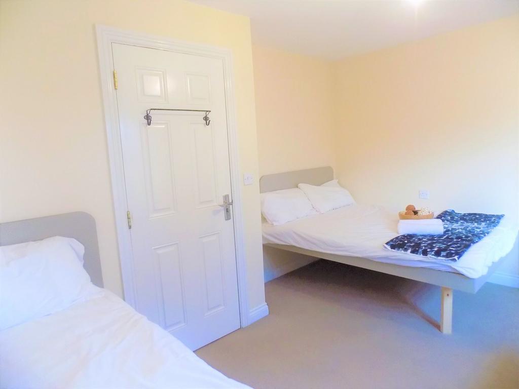 A bright and tidy double bedroom featuring two ...