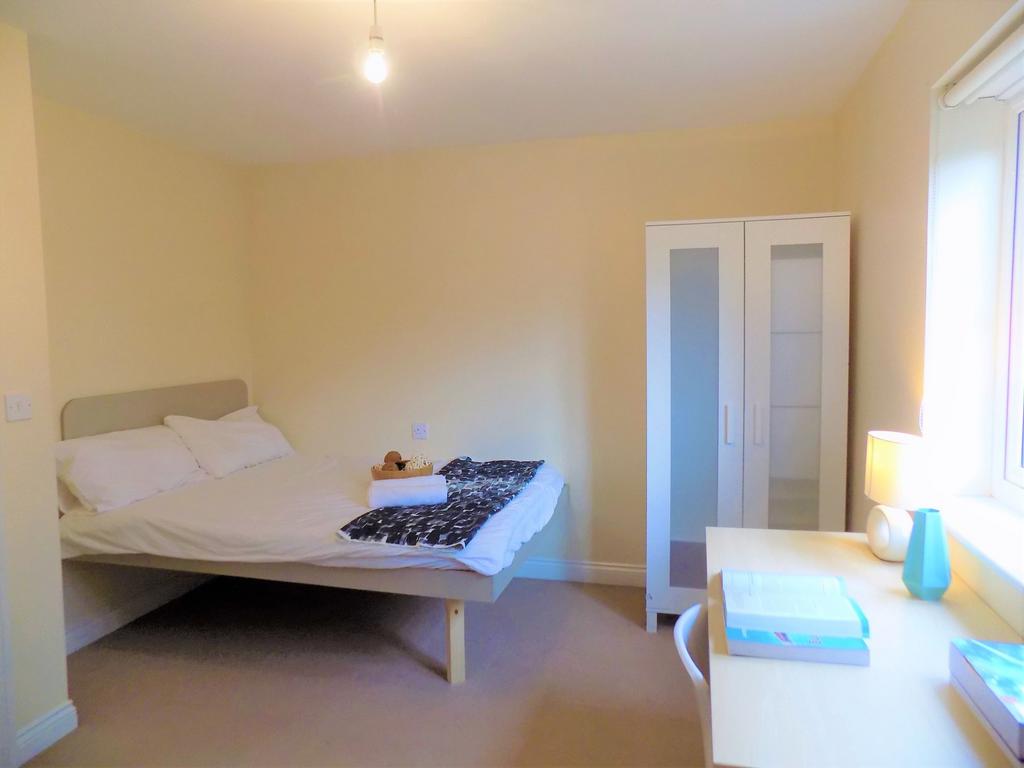 A bright and tidy double bedroom featuring a ne...