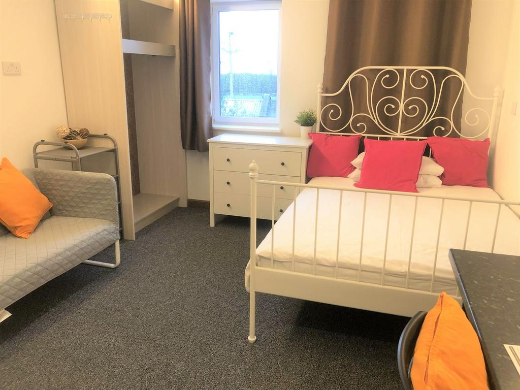 A bright and tidy double bedroom featuring a st...