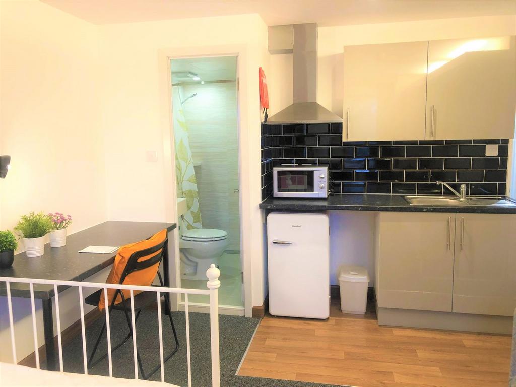 Bright and tidy living space featuring a compac...