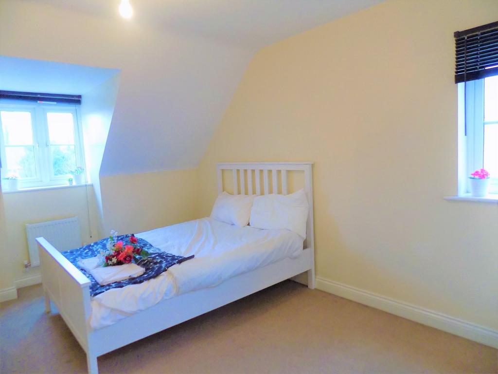Bright and cozy double bedroom featuring a comf...