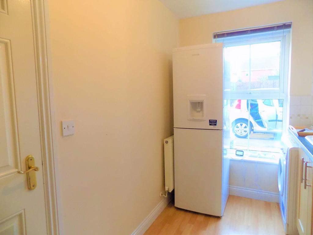 Bright kitchen area with a modern fridge freeze...
