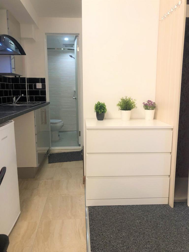 A compact and tidy kitchenette area with modern...