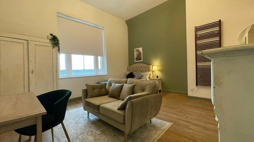 A spacious and stylish modern living room, feat...