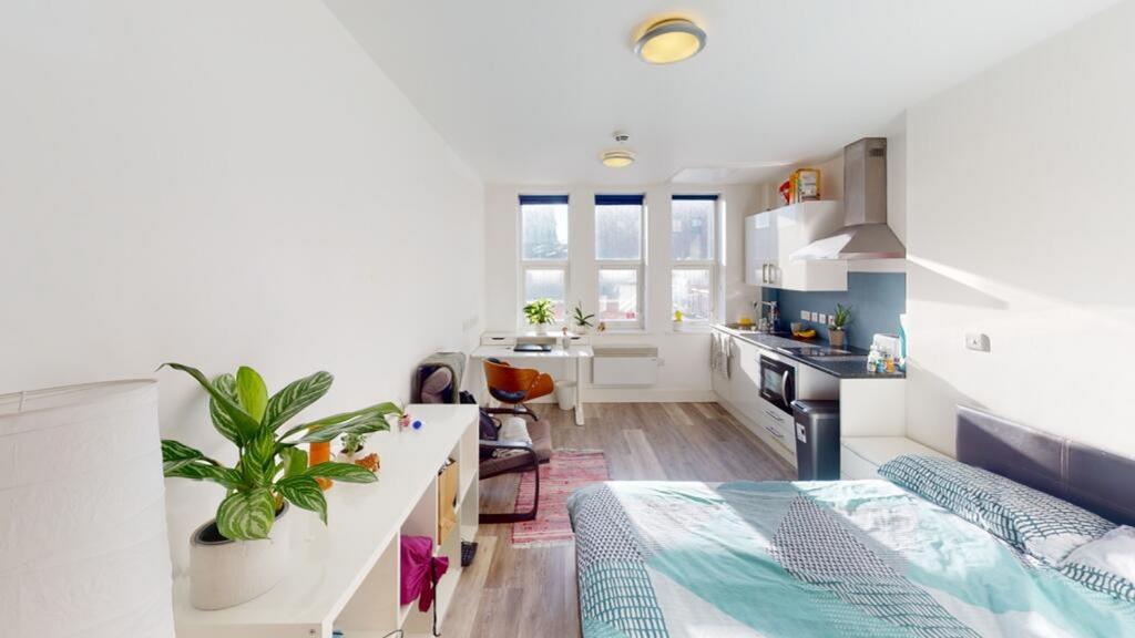 A stylish double bedroom featuring large window...
