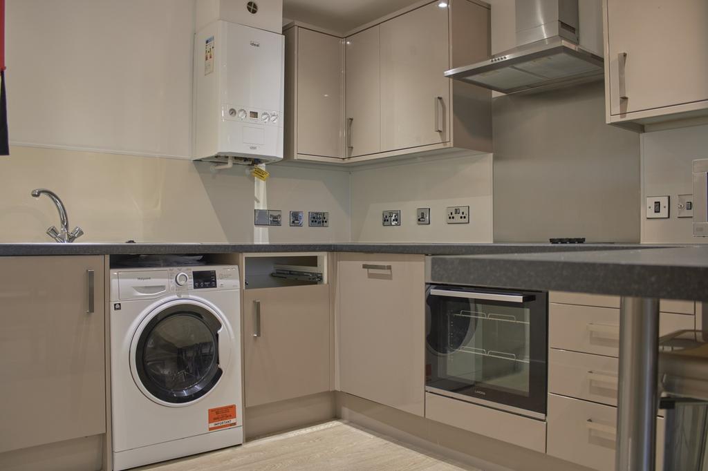 A modern and tidy kitchen featuring essential a...