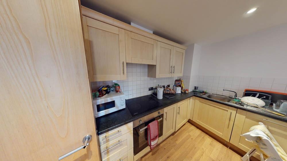 A modern kitchen featuring light wood cabinets ...