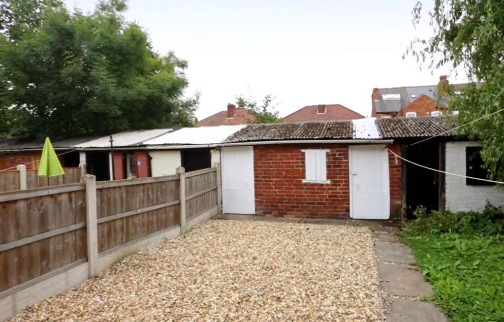 A neat, well-maintained garden area with a pave...