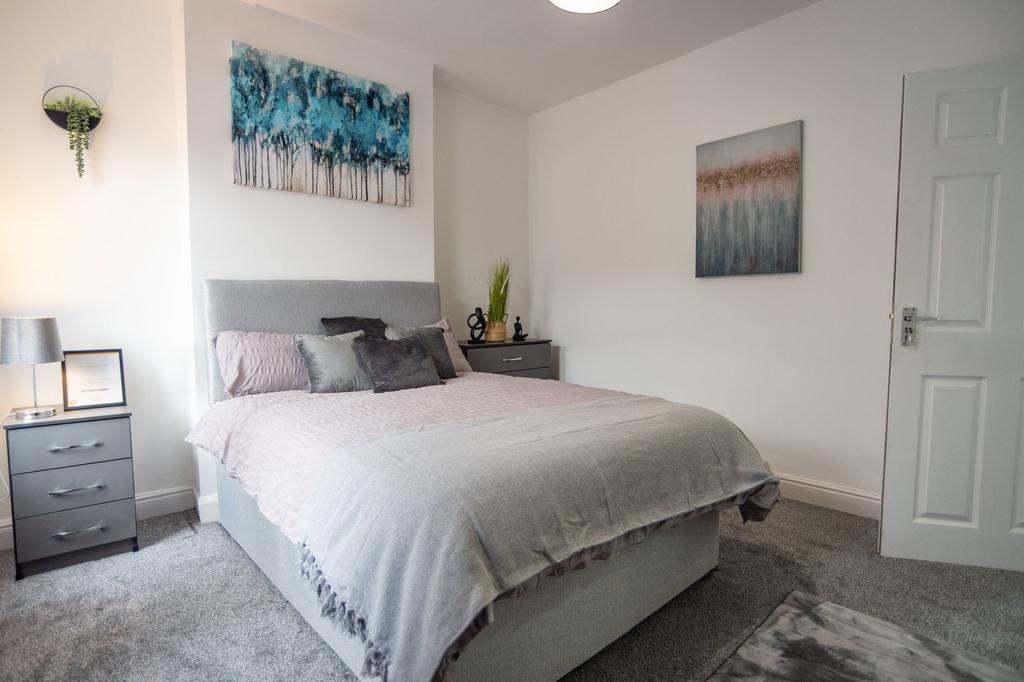 A bright and inviting double bedroom featuring ...
