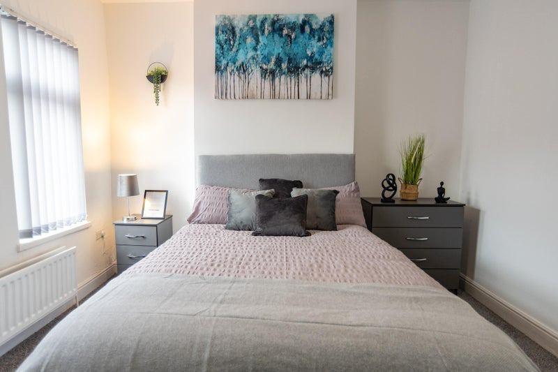 A cozy double bedroom featuring a comfortable d...