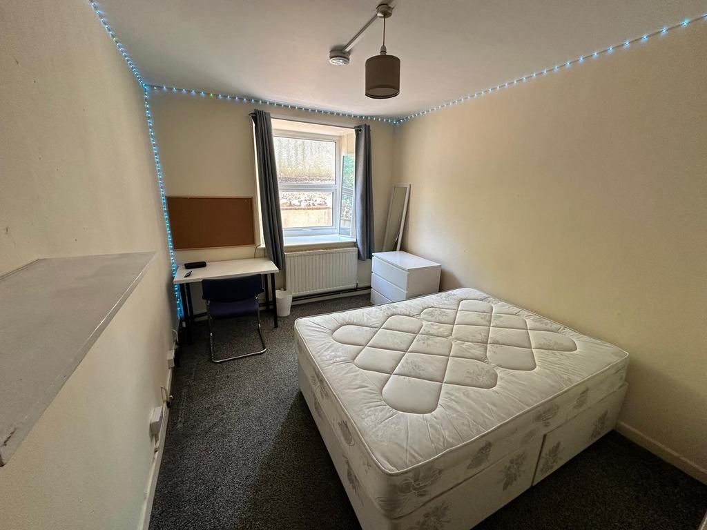 A bright and spacious double bedroom featuring ...
