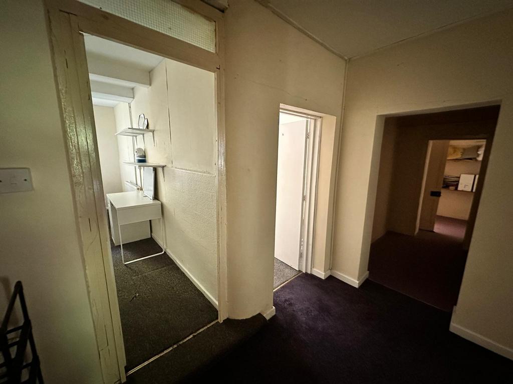 A spacious and tidy hallway providing access to...