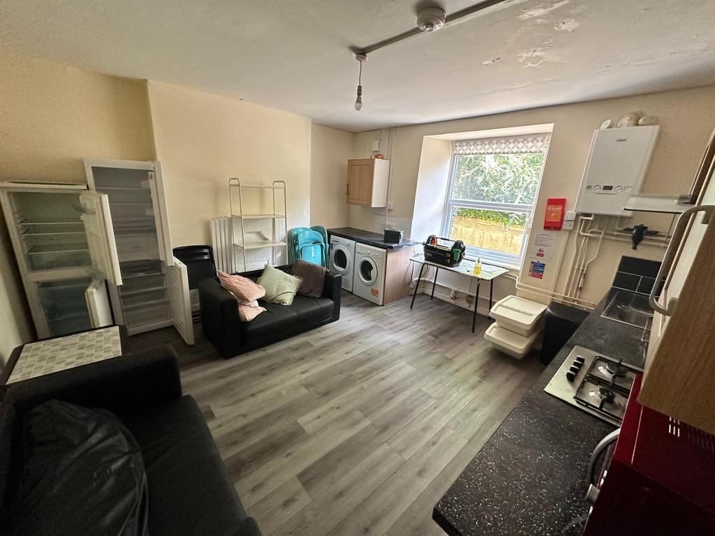 A spacious and well-lit kitchenette with modern...