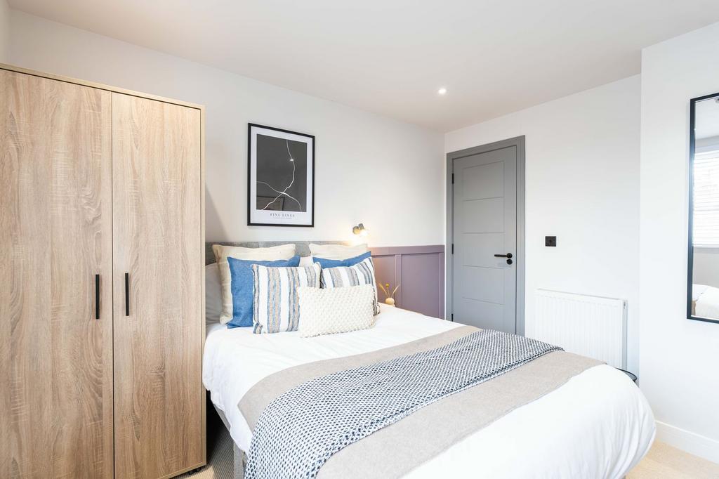 Bright and welcoming master bedroom featuring a...
