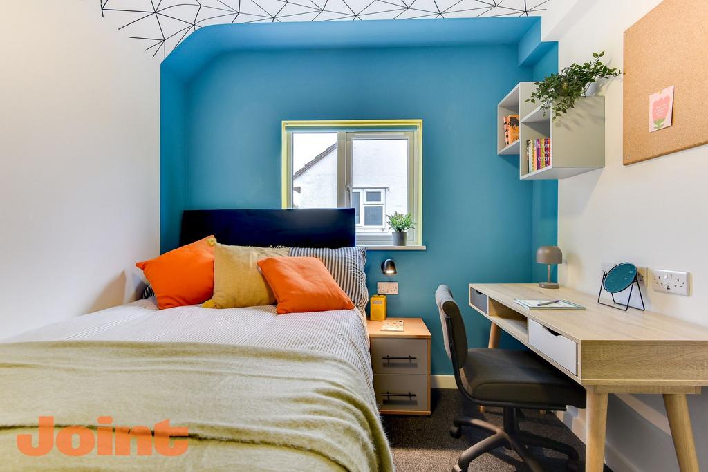 Bright, well-styled bedroom with a double bed d...