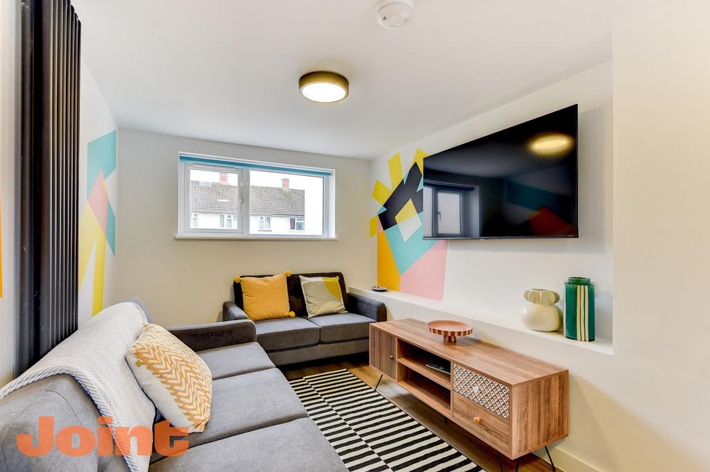 Bright, modern living room with comfortable gre...