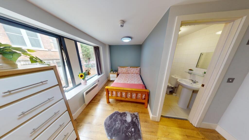 A bright and spacious double bedroom featuring ...