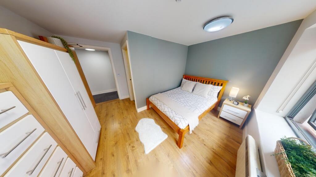 A bright and inviting double bedroom with moder...