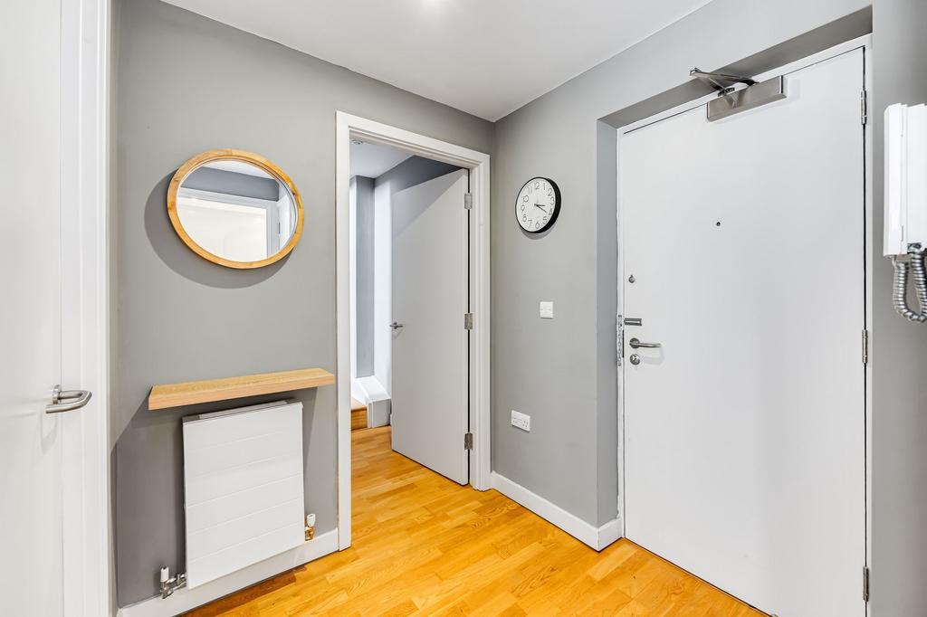 A clean and modern hallway featuring light wood...