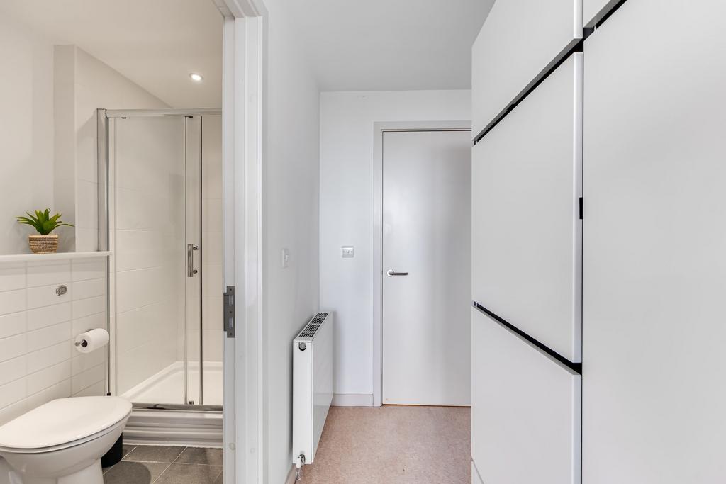 A clean and modern single toilet area featuring...