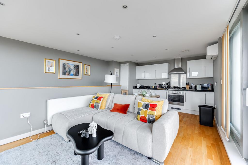 Bright and modern living room featuring a comfo...