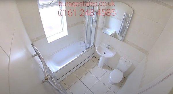 Bright and clean bathroom featuring a bath with...