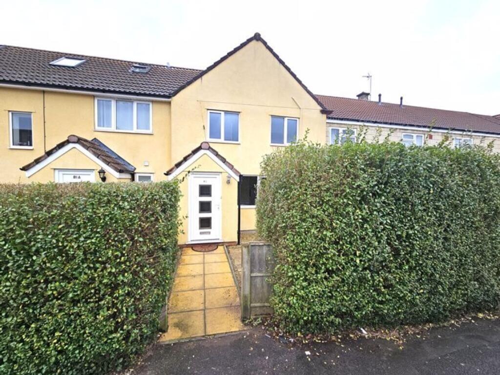 A well-maintained terraced house with a neat fr...