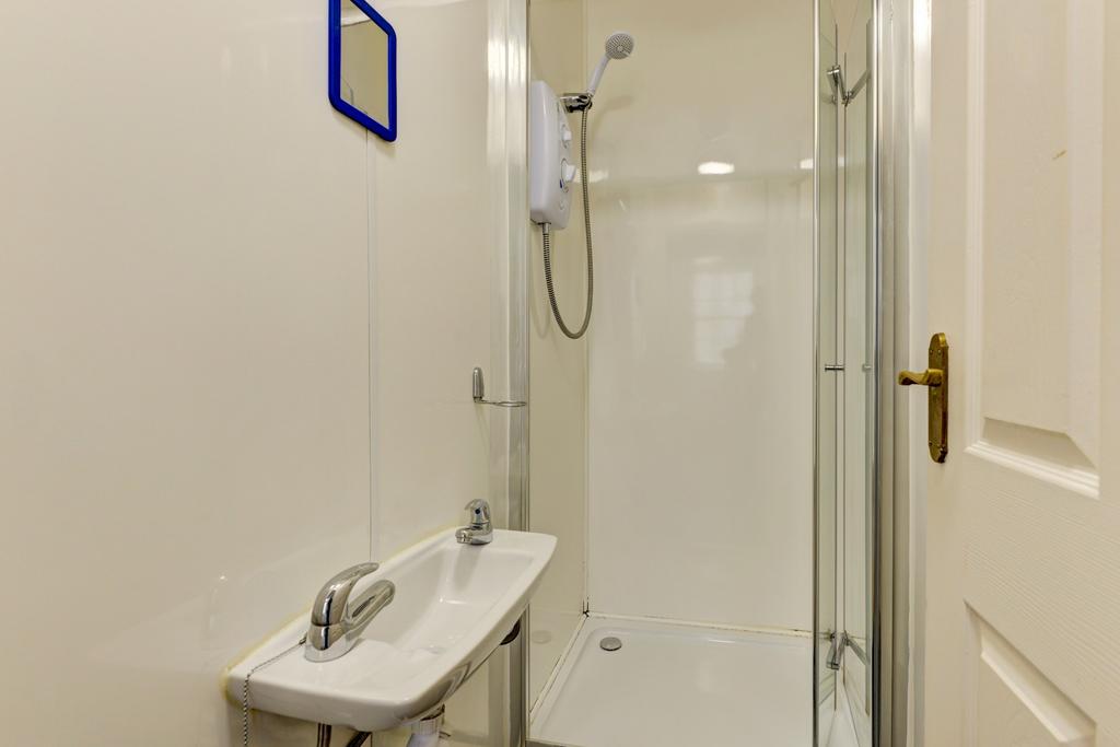 A clean and bright bathroom with essential fixt...