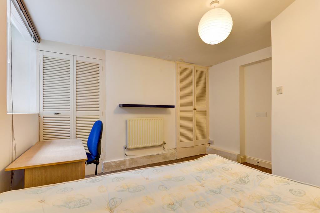 A bright and well-maintained bedroom featuring ...