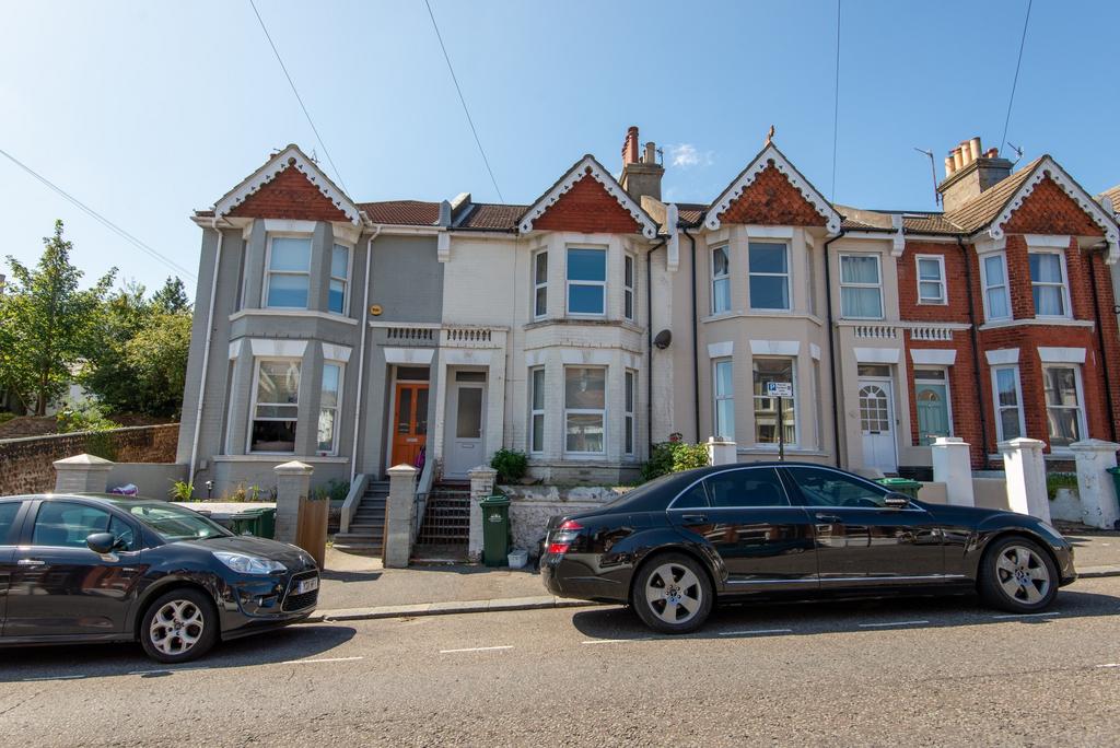 A charming row of terraced houses featuring att...
