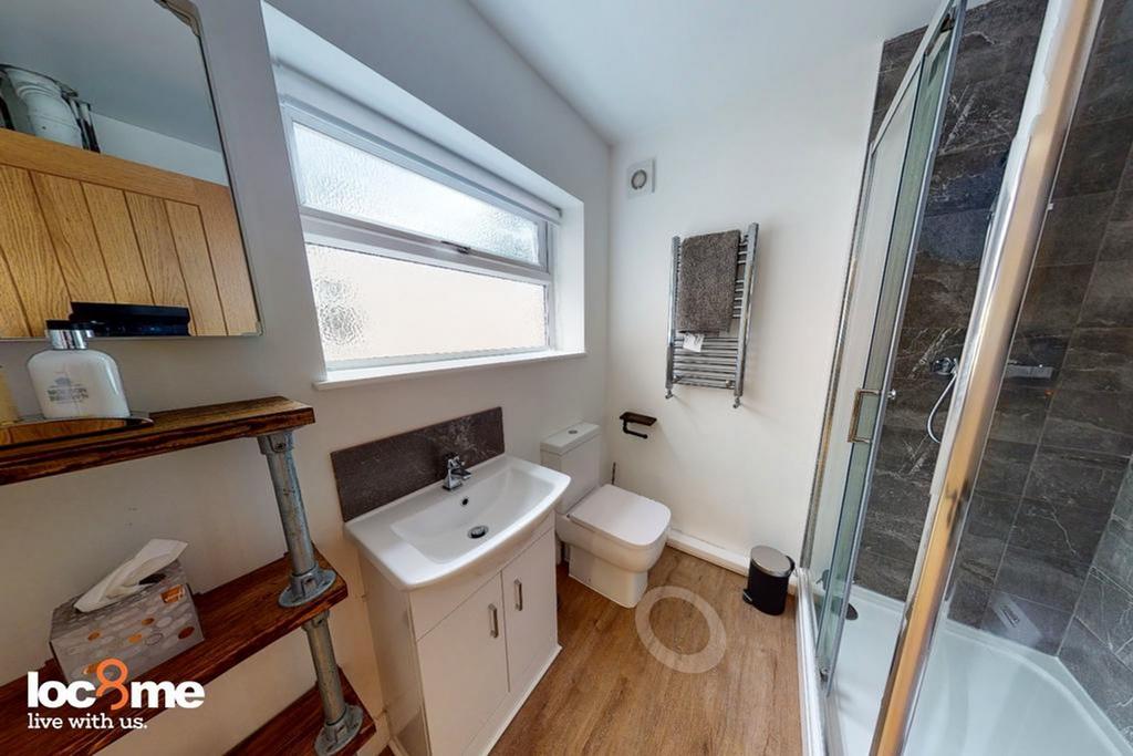 A modern and tidy bathroom featuring a spacious...