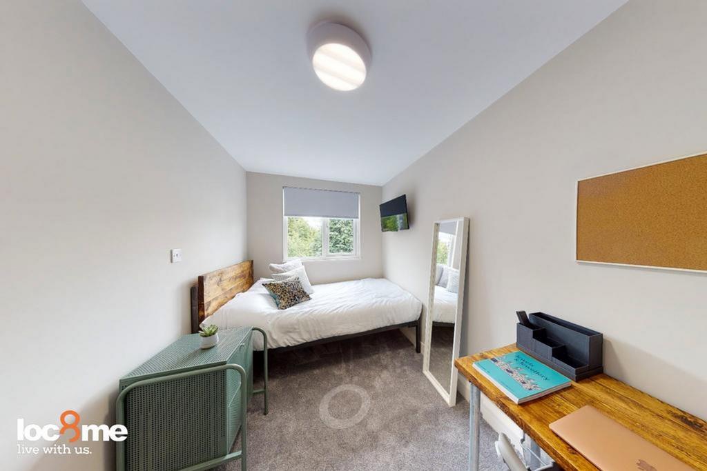 A bright and inviting double bedroom featuring ...