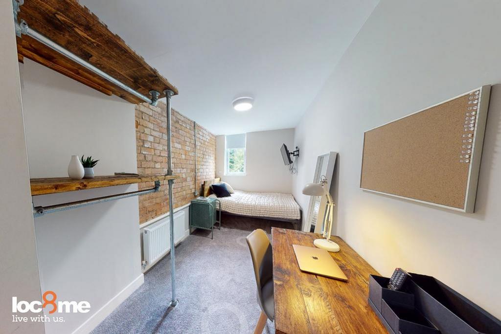 A stylish and well-lit double bedroom featuring...