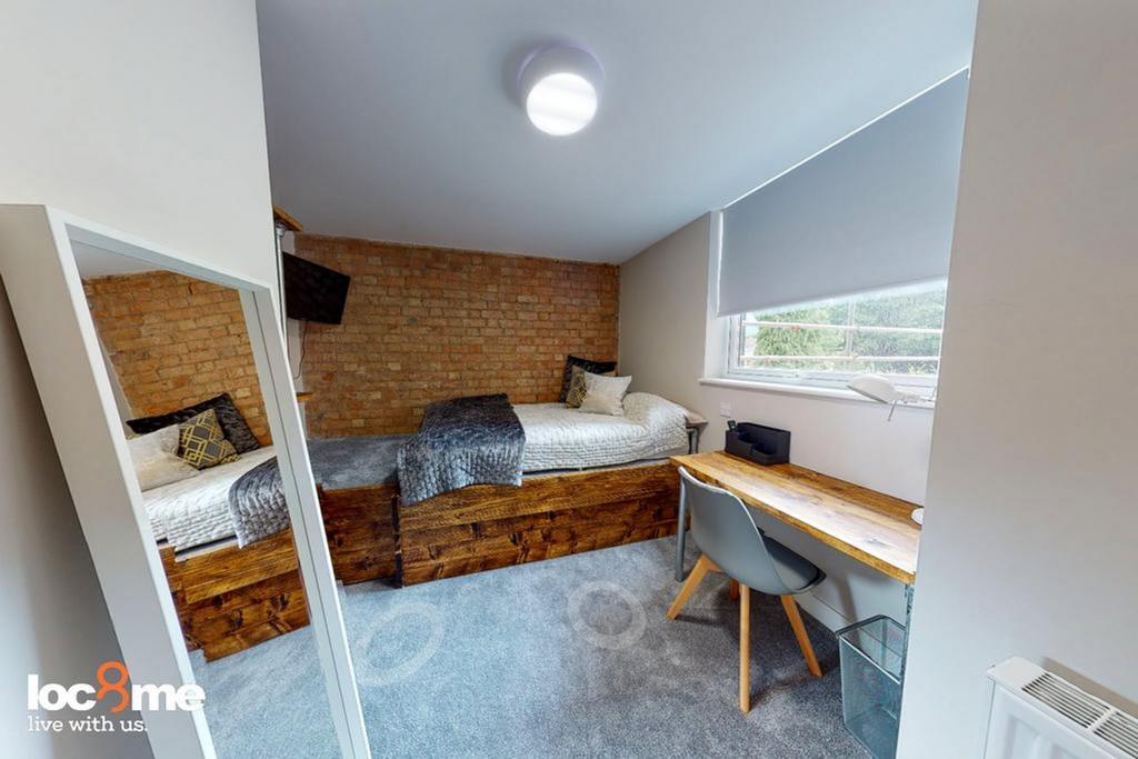 A bright and inviting double bedroom with a sty...