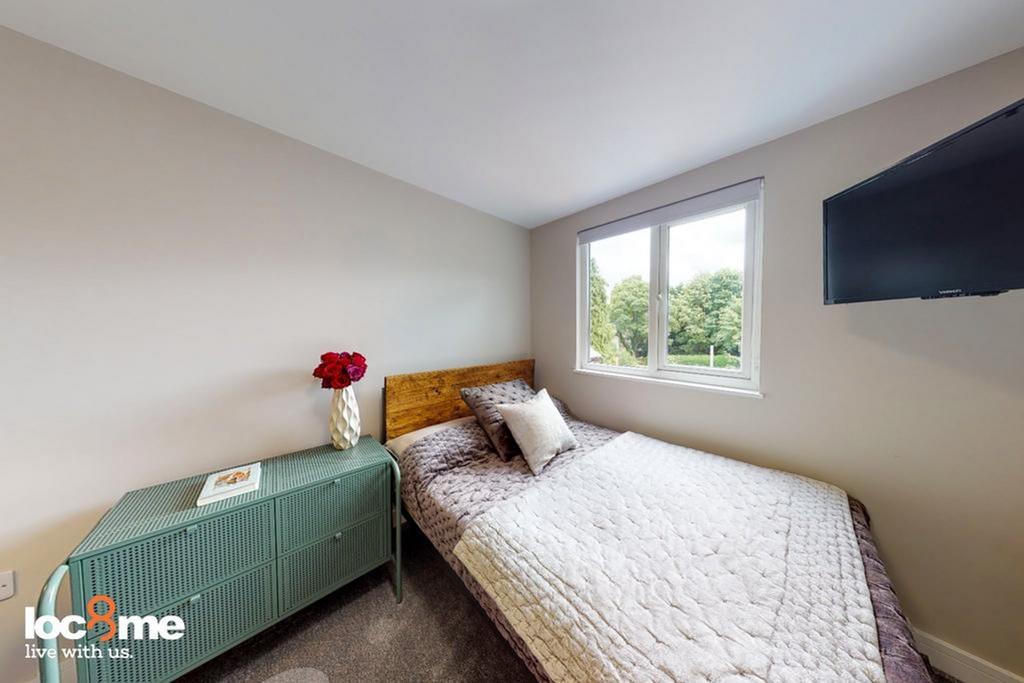 A cozy and well-lit double bedroom, perfect for...