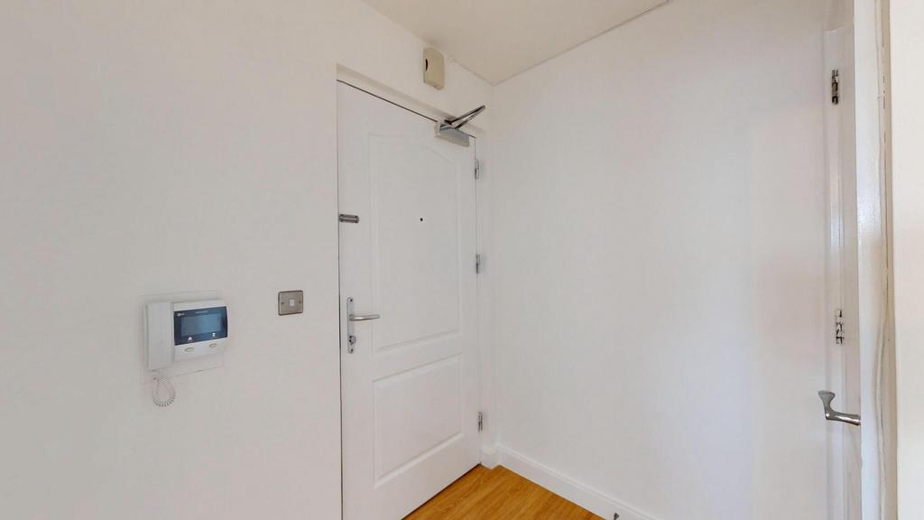 Bright and clean hallway with white walls and w...