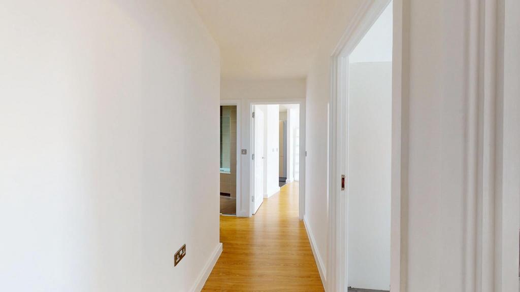 Bright and clean hallway with light wooden floo...