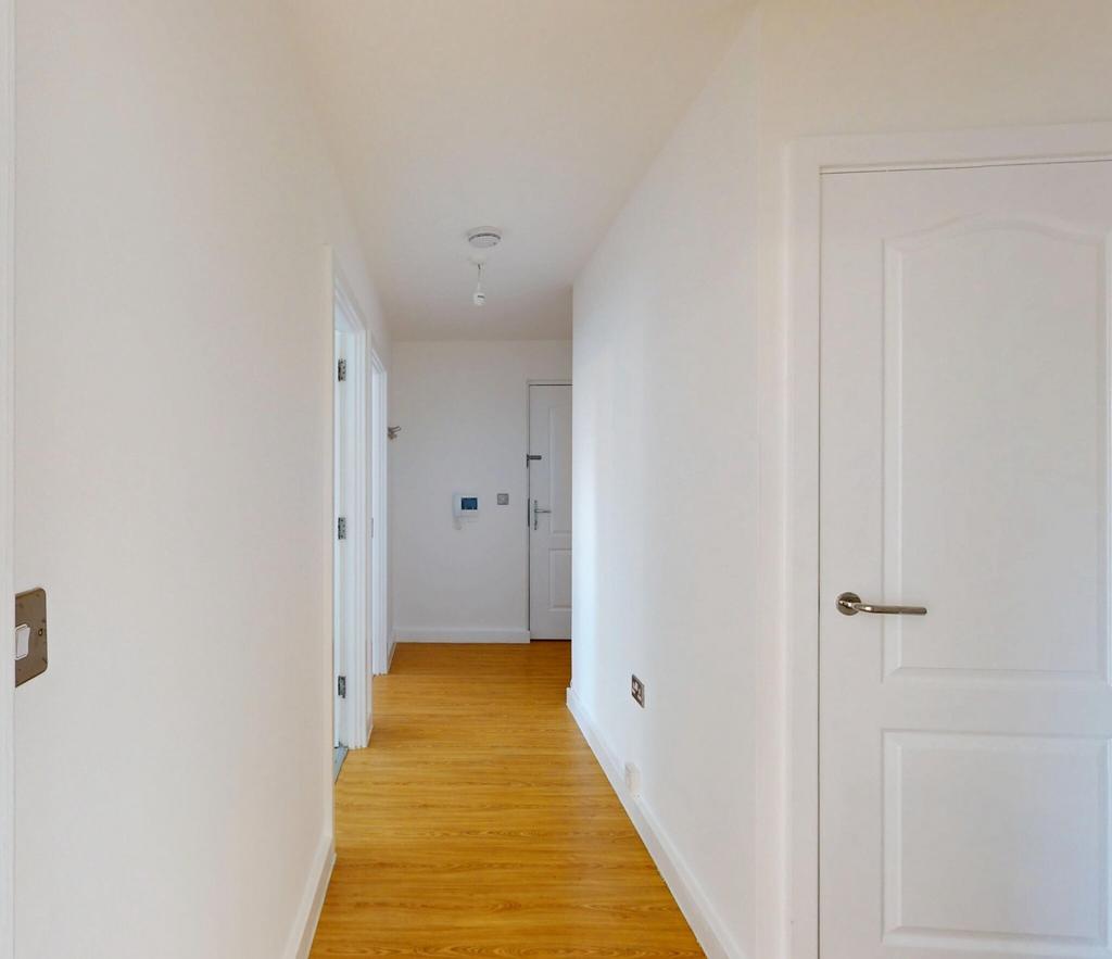 A clean and well-maintained hallway with white ...