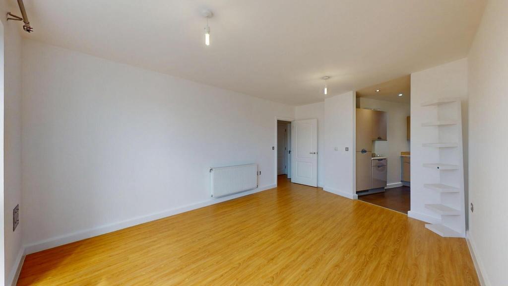 A bright and spacious living room featuring cle...
