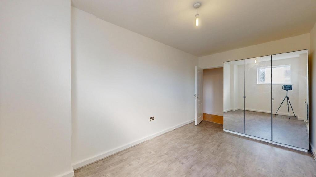 A bright and clean double bedroom featuring a l...